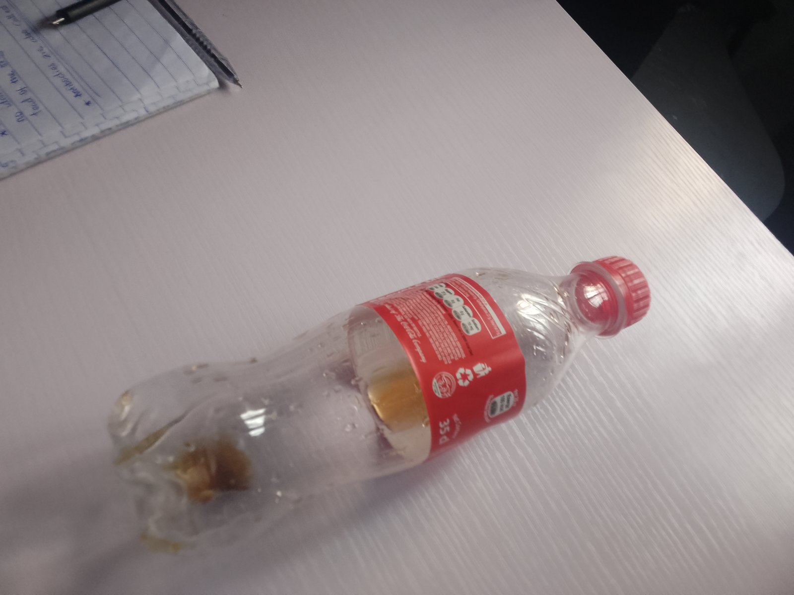 Clear PET bottle showing the shoulder profile and the applied label